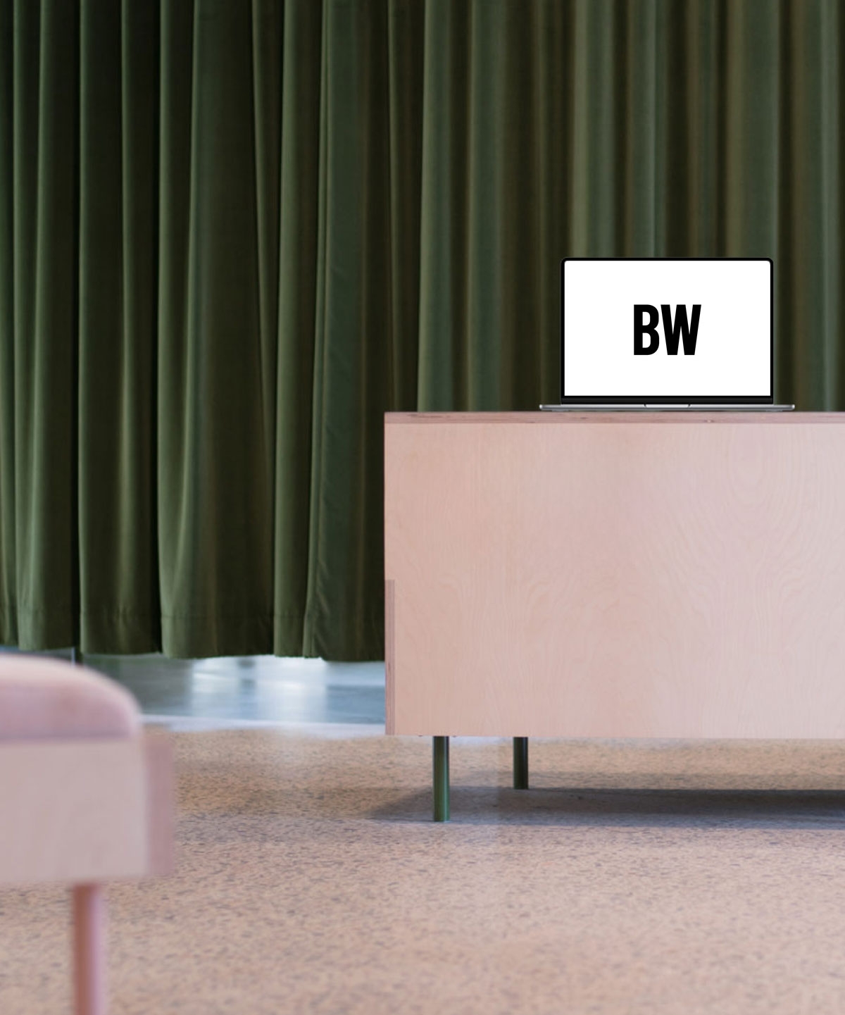 BresicWhitney logo on homepage displayed on laptop monitor in a modern office