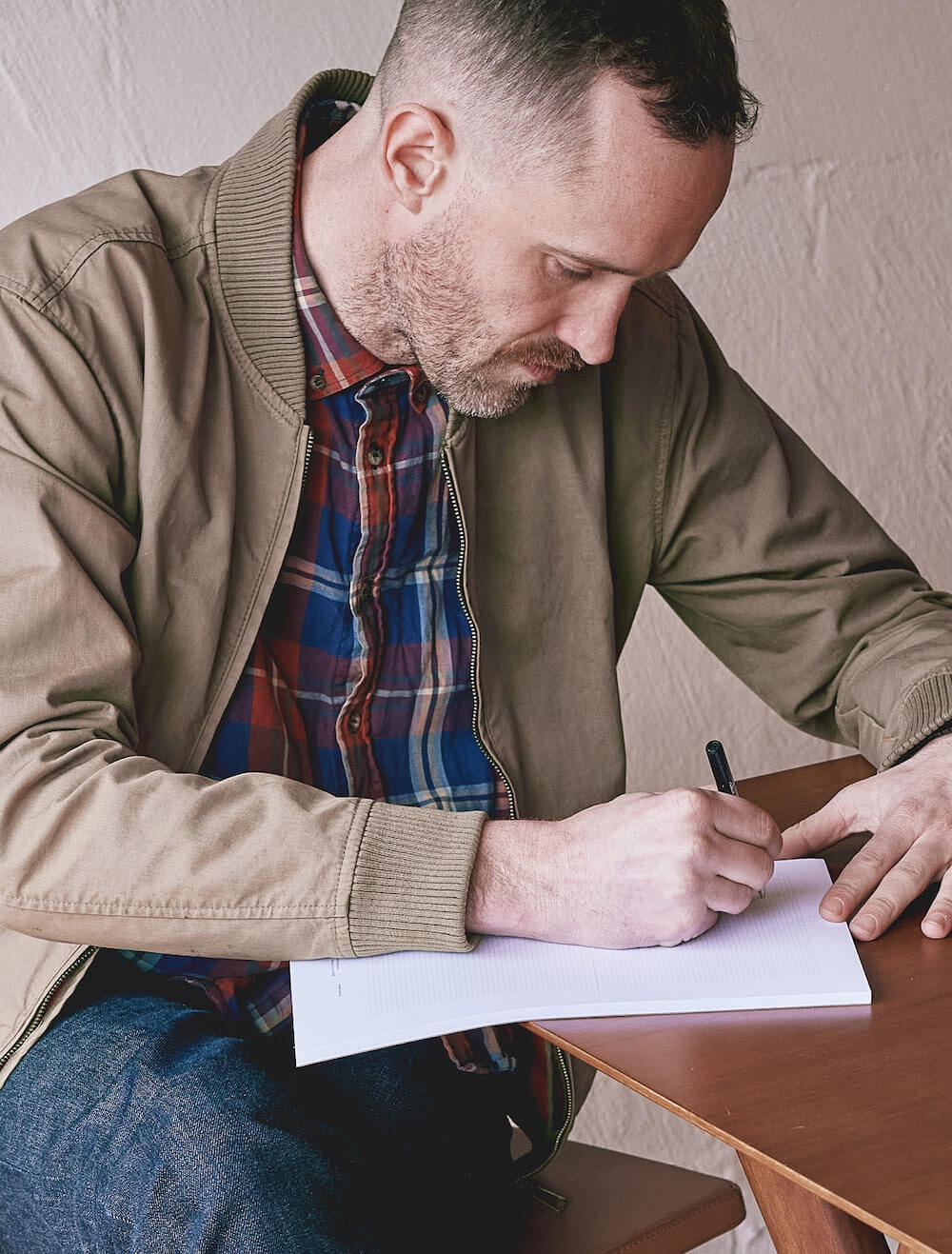 Nick Thorn Director - Writing in a note wireframing notepad. Collingwood Studio | Atollon - Brand Agency Melbourne