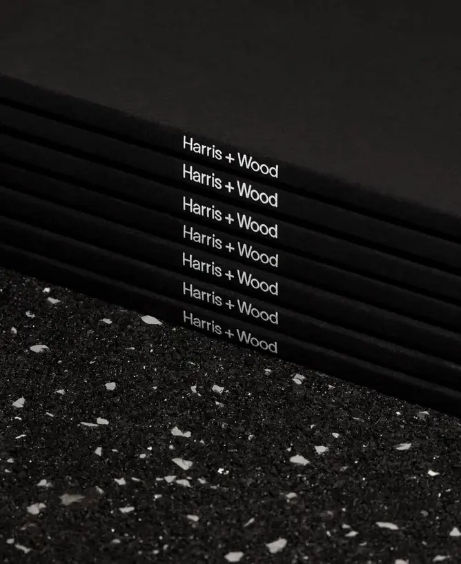 Stacked Harris + Wood folders with logo printed on the spine