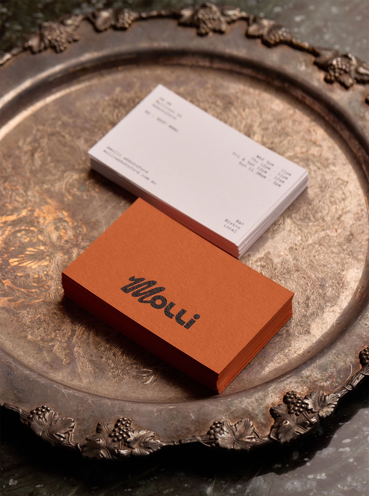 Molli business cards on an ornate silver tray