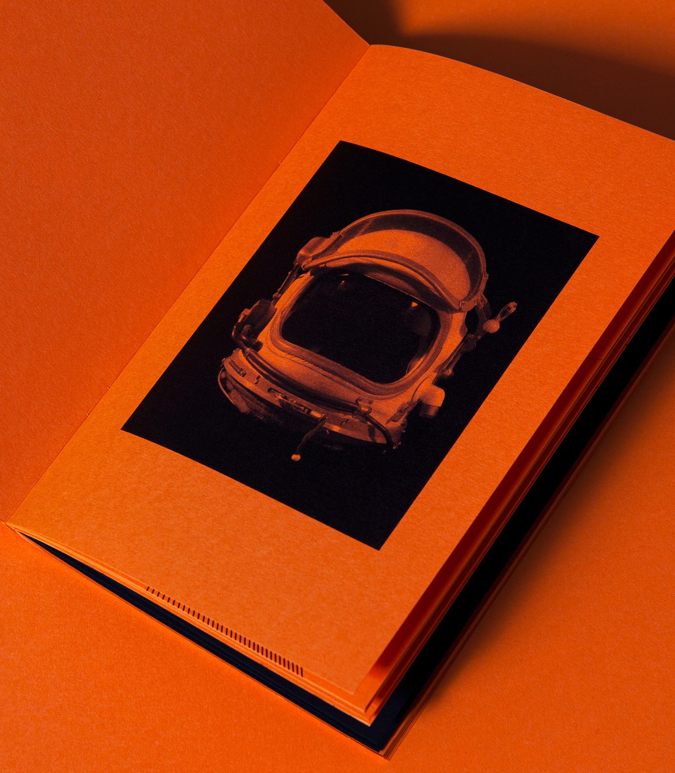 FSC Universe spread with astronaut helmet image on orange paper stock